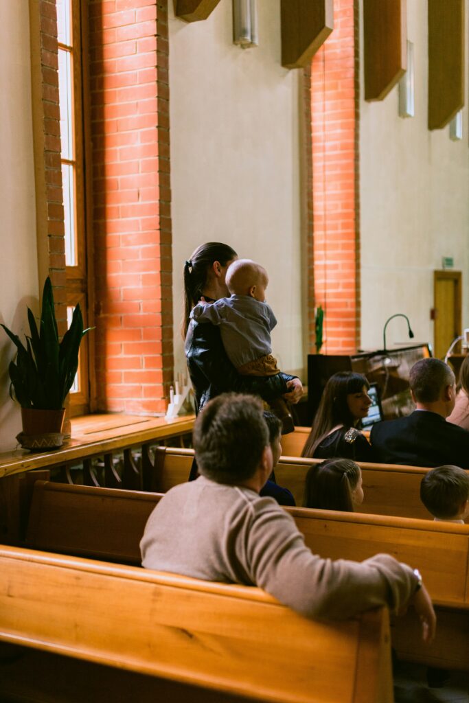 Families sitting together in church pews during an all-age family service